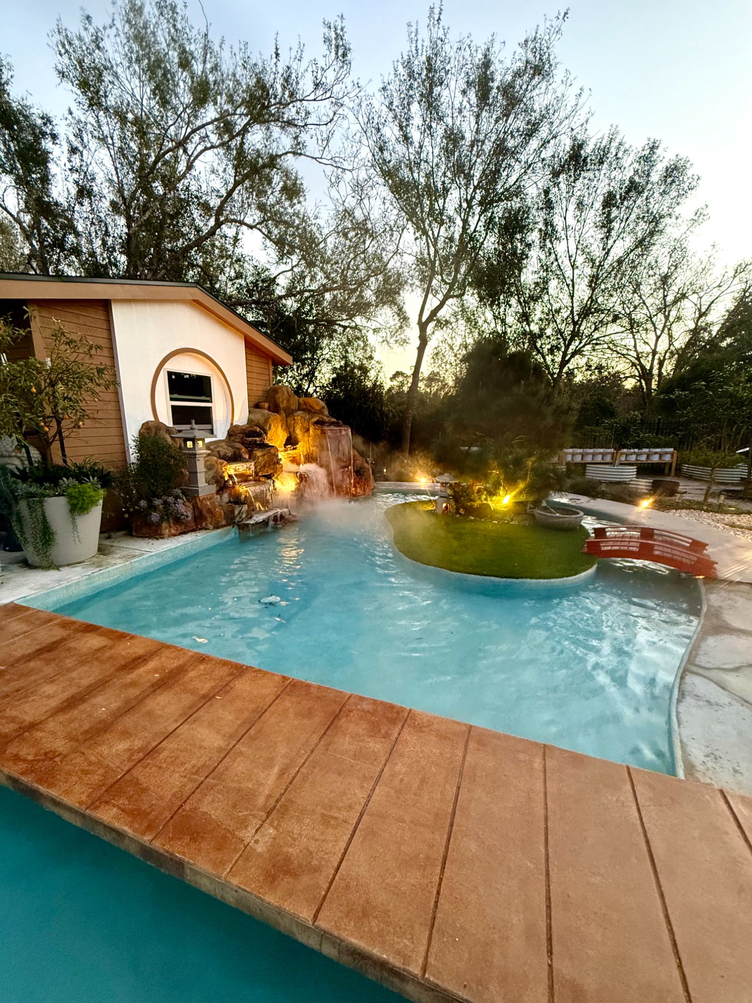 Pool with rock waterfall at dusk
